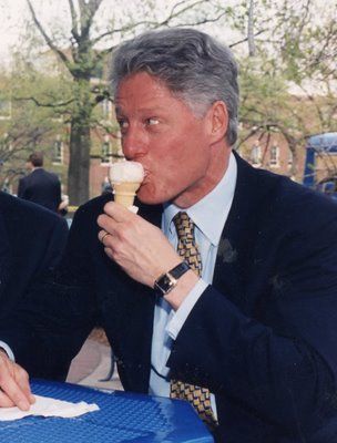 Bill Clinton eating an ice cream cone outdoors