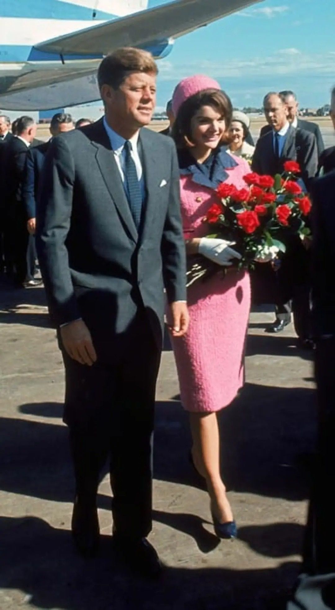 John F. Kennedy walking with Jacqueline Kennedy near an airplane