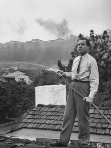 Richard Nixon watering a hillside with a garden hose