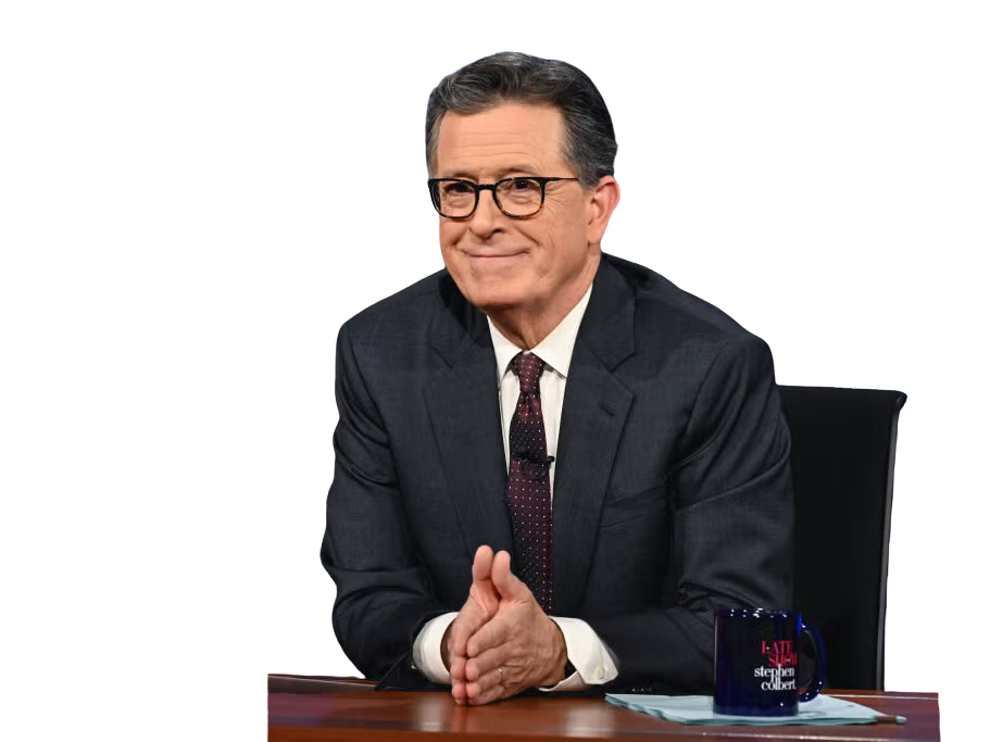 Stephen Colbert seated at a desk