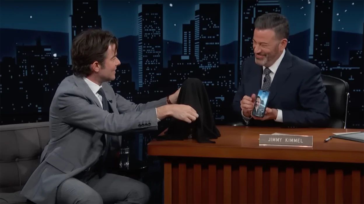 Jimmy Kimmel interviewing a guest at the Jimmy Kimmel Live desk