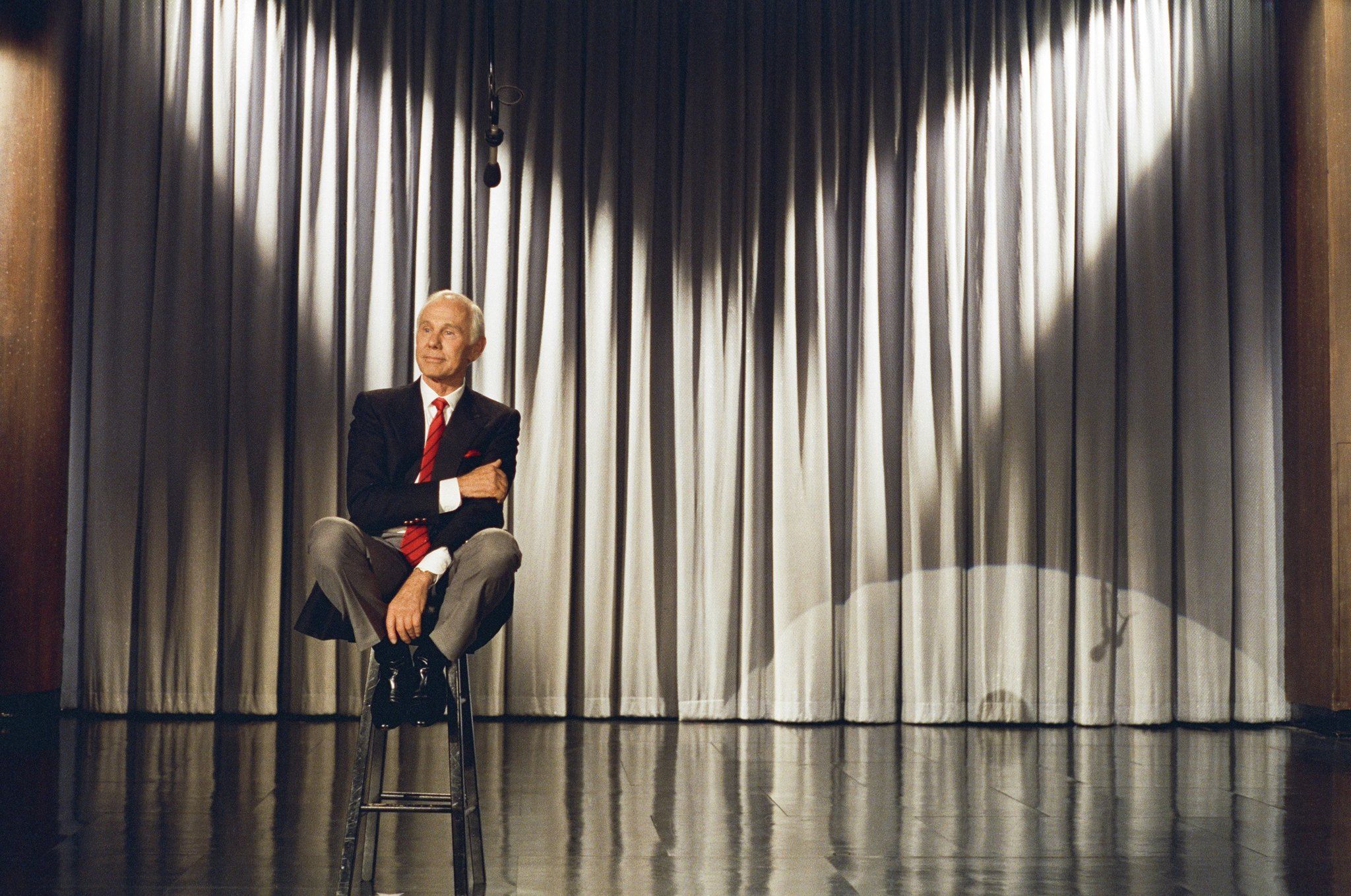 Johnny Carson seated on stage